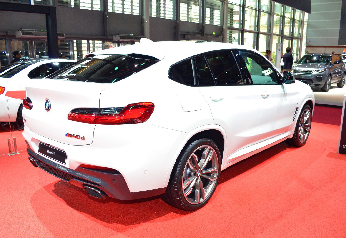 Rear and side profile of a sporty luxury SUV with sleek tail lights and alloy wheels