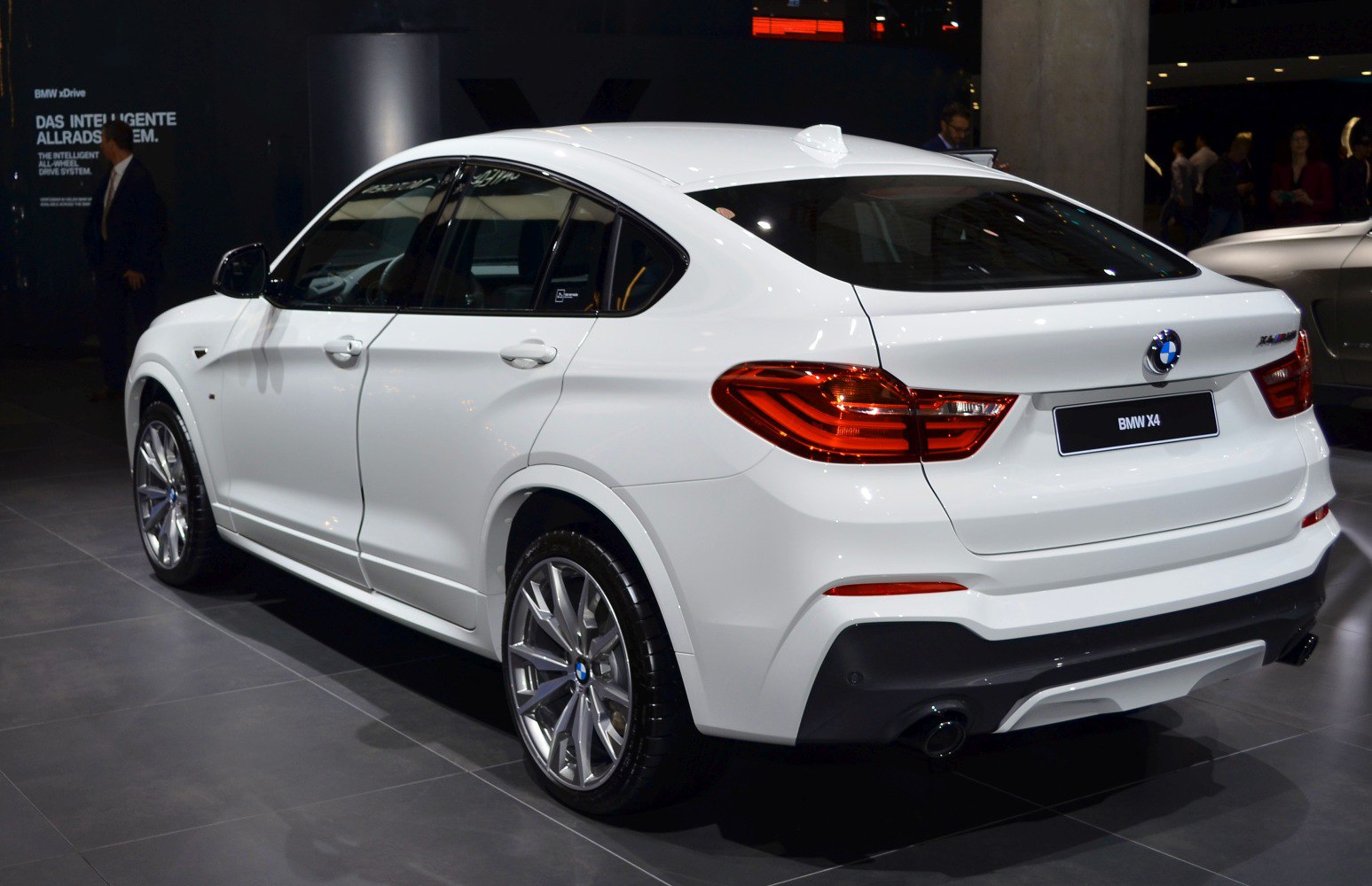 Luxury white SUV rear side with distinctive taillights and alloy wheels.