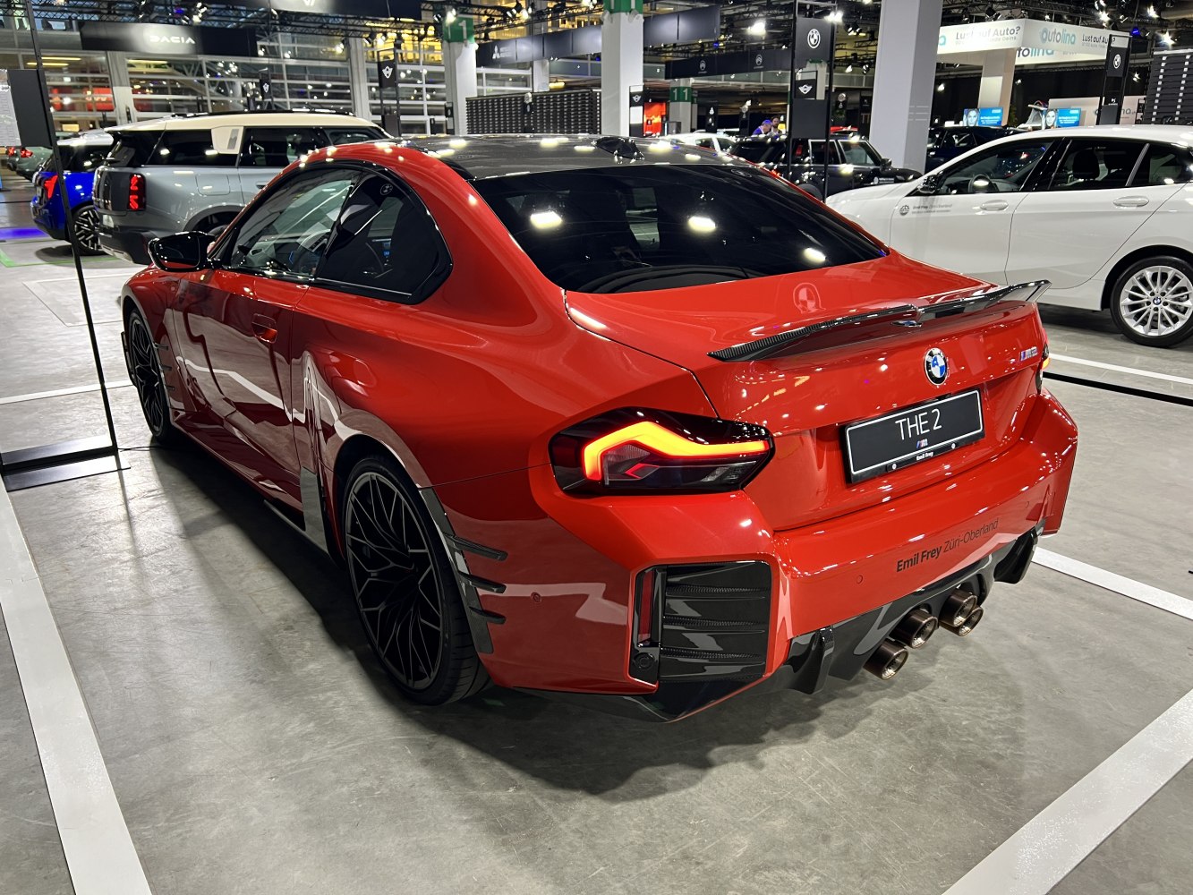 Rear view of sporty coupe with carbon spoiler and quad exhaust