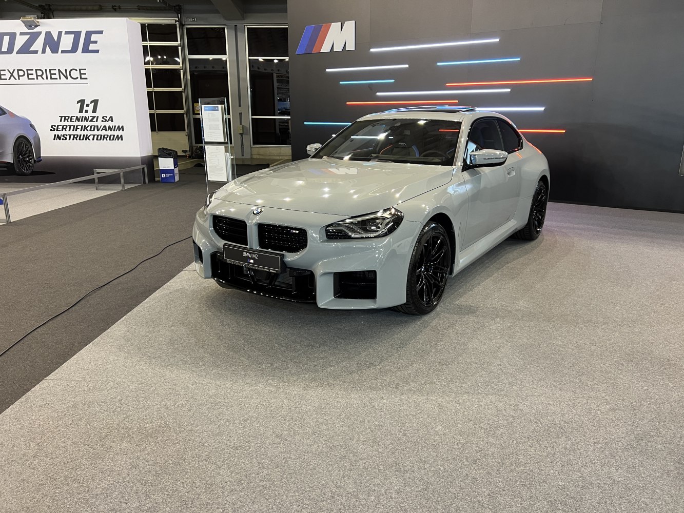 Sporty coupe front view with kidney grille and black alloy wheels