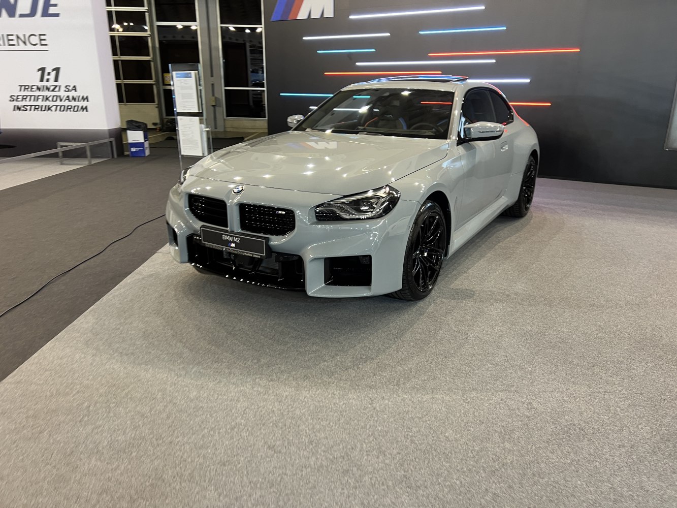 Sporty front angle view with black wheels and aggressive bumper