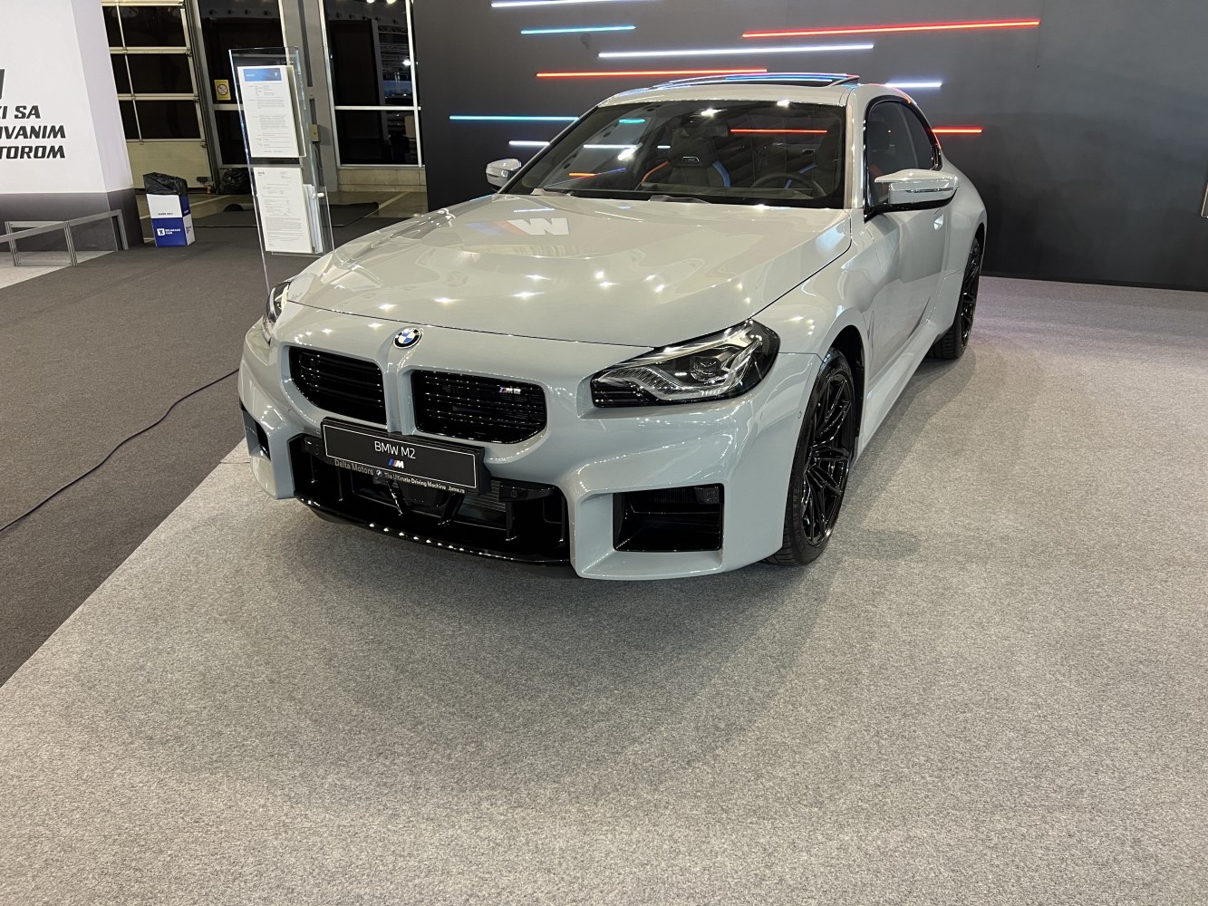 Front view of modern sports coupe with aggressive grille and sharp headlights.