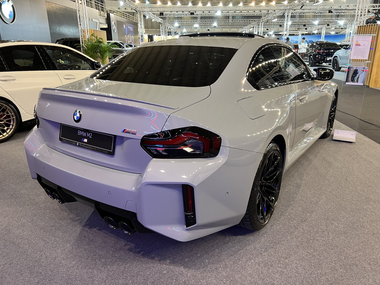 Rear view with spoiler, quad exhaust, and distinctive taillights