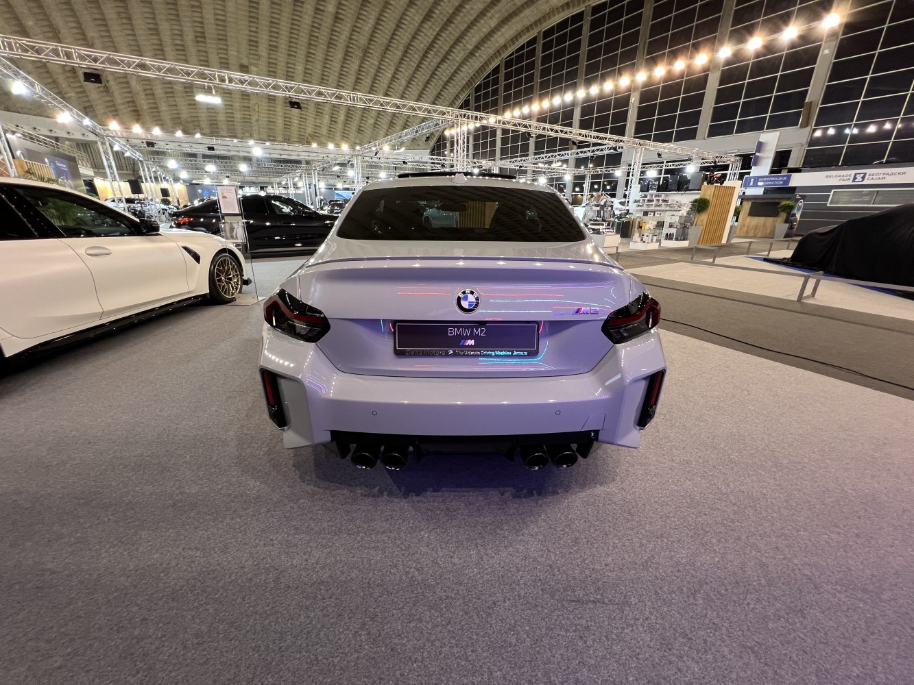 Rear view of a sports sedan with quad exhaust and LED tail lights