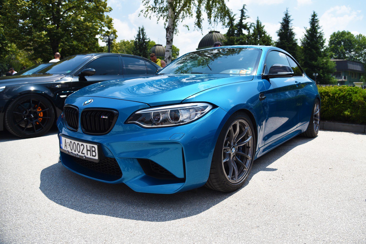 Front view of blue BMW M2 coupe with aggressive grille and alloy wheels