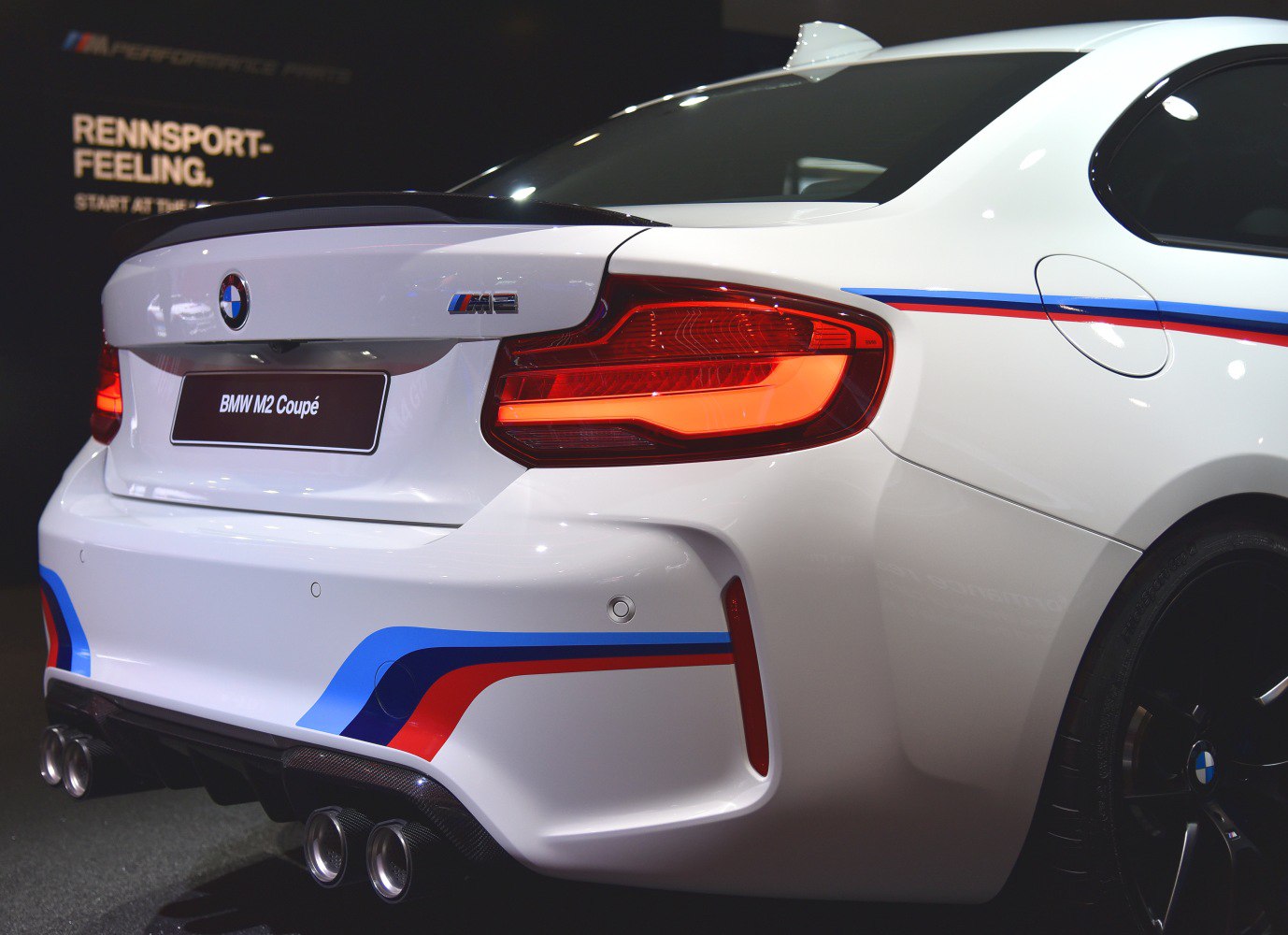 Rear view of sporty quad exhausts and taillights with M-stripe accents