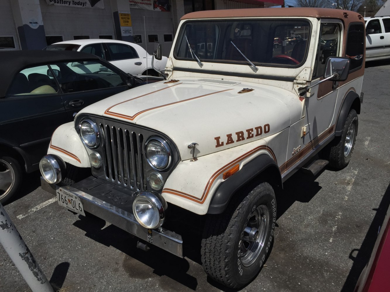 Off-road vehicle with round headlights, chrome grille, two-tone hardtop