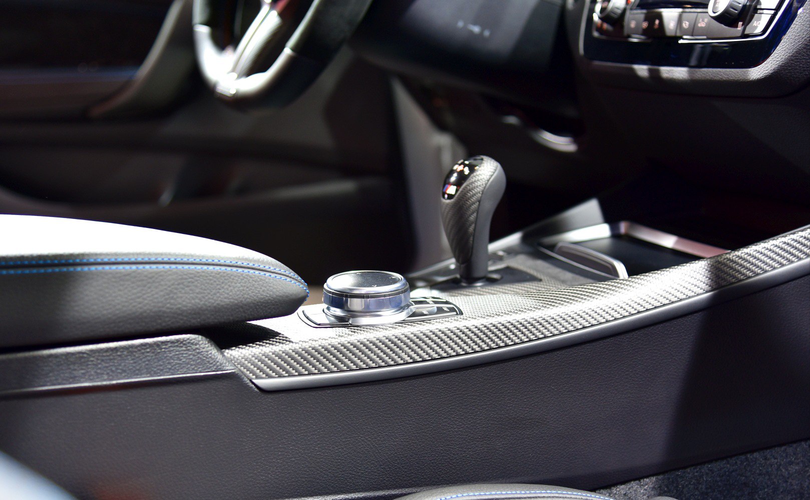 Carbon fiber center console with M logo gear shifter in luxury sports car interior
