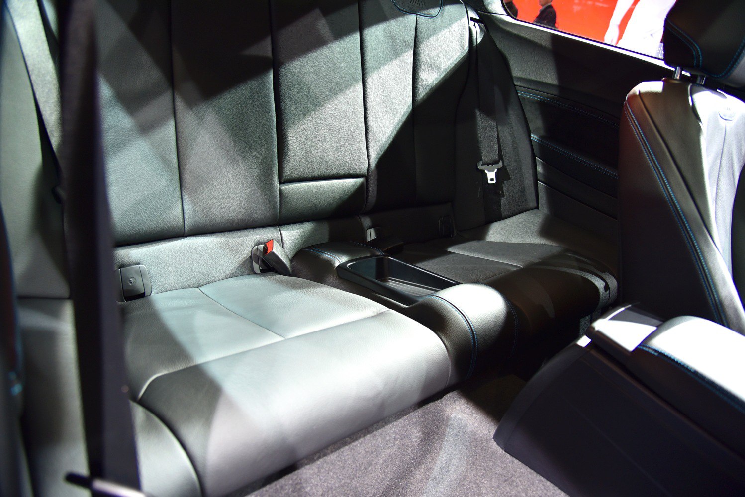 Rear leather seats with center armrest and seatbelt
