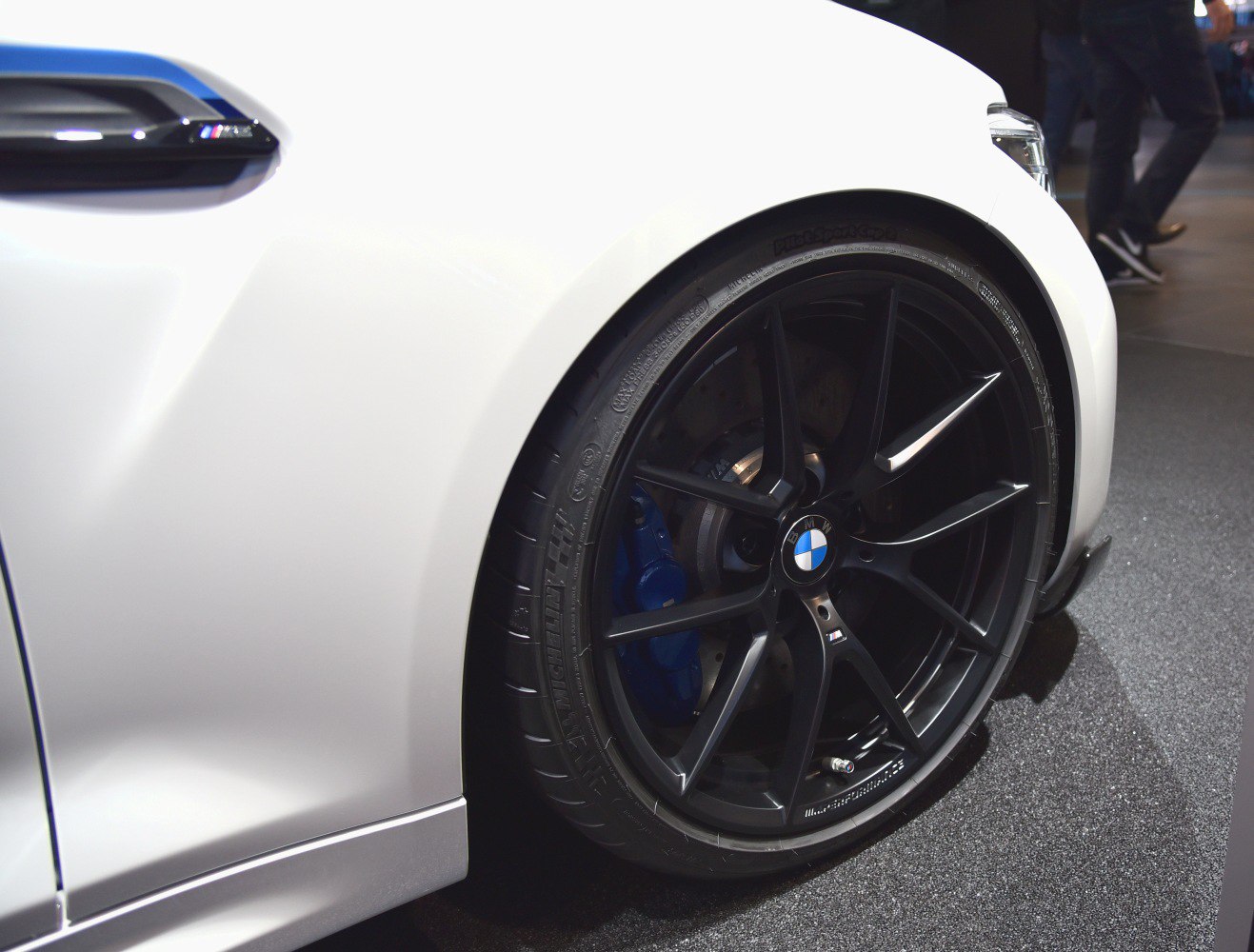 Black alloy wheel and blue brake caliper on a sports car