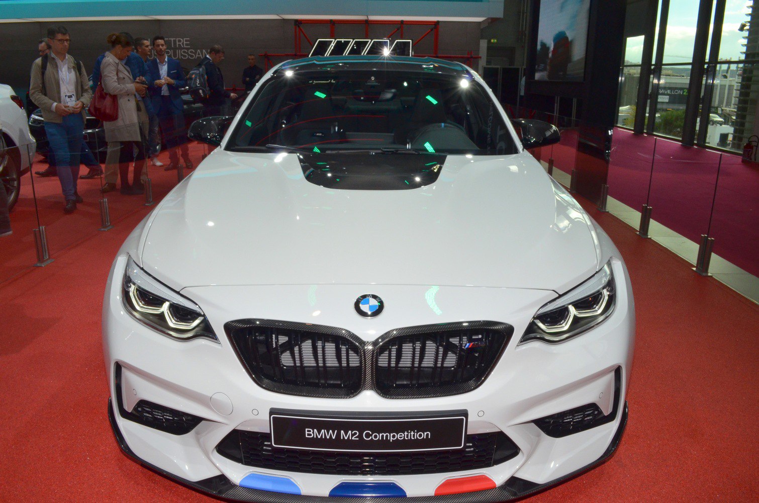 Front view with aggressive grille and carbon fiber hood