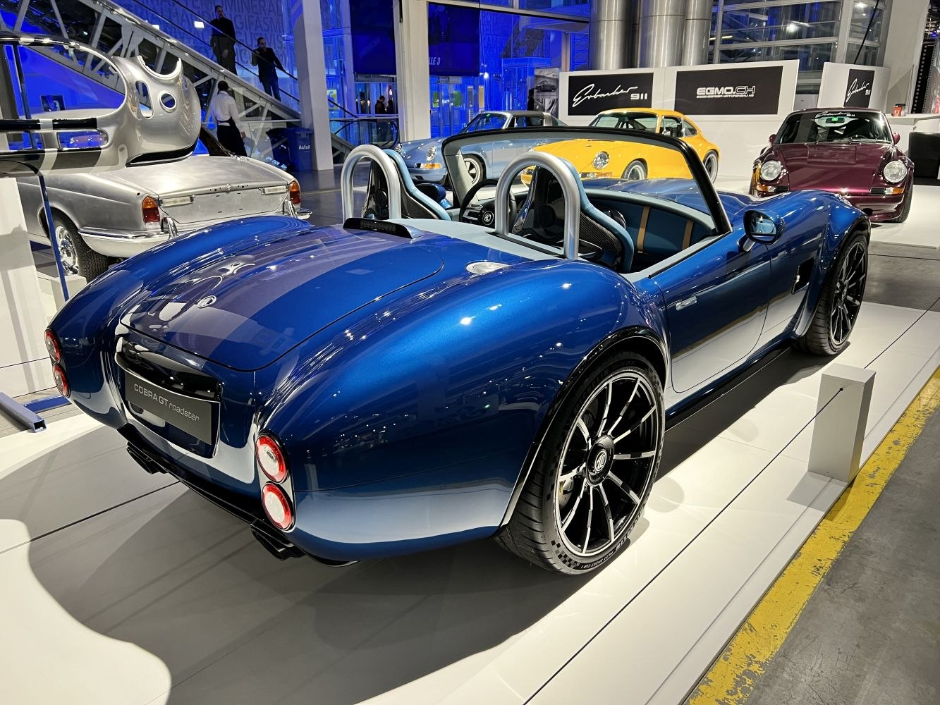 Blue open-top two-seater roadster with sporty wide wheels