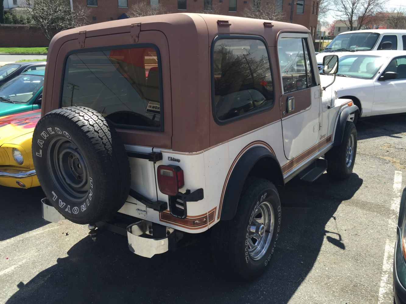 Compact vintage SUV with hardtop roof and rear-mounted spare tire