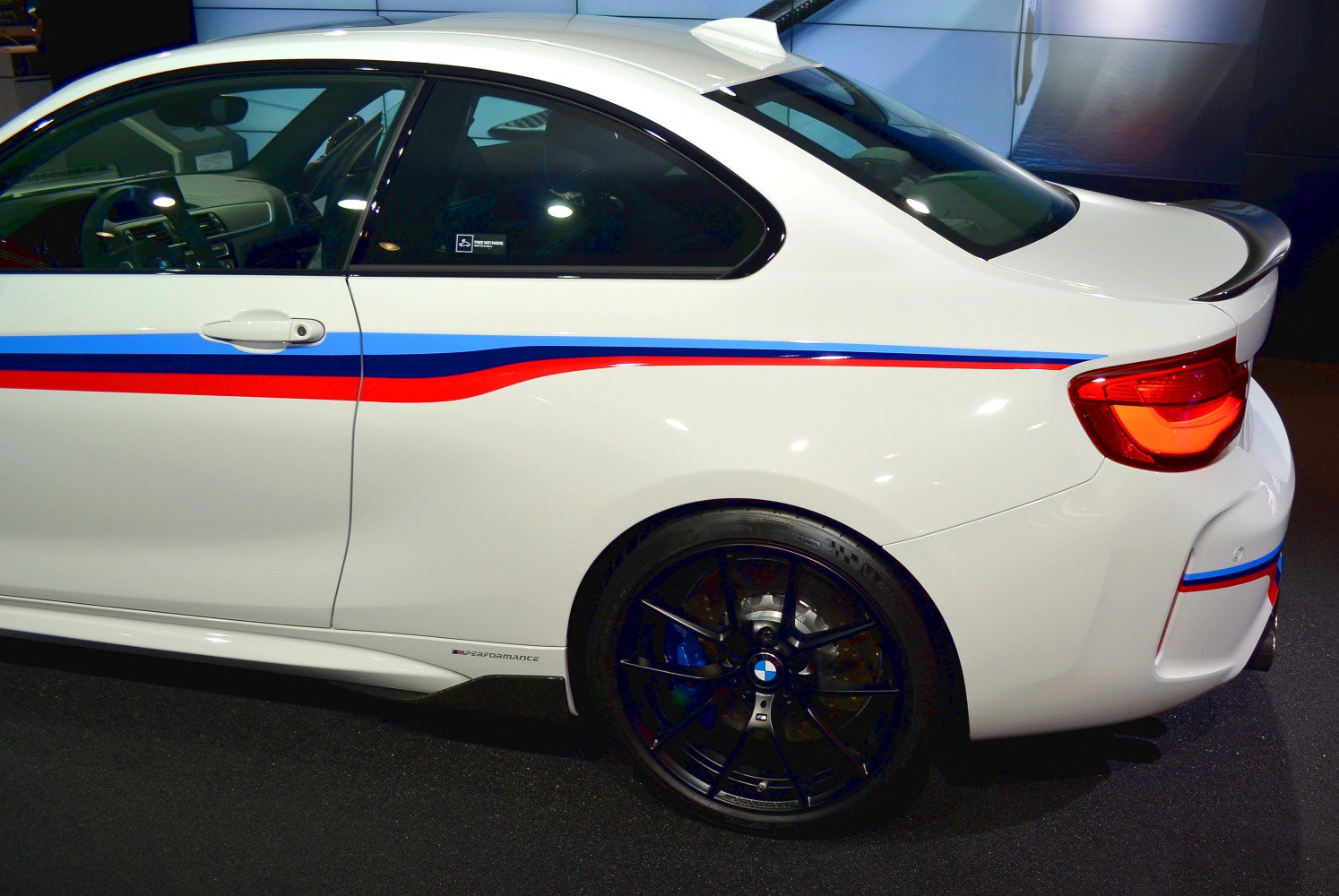 Side view of rear with M Performance stripes and black multi-spoke wheels