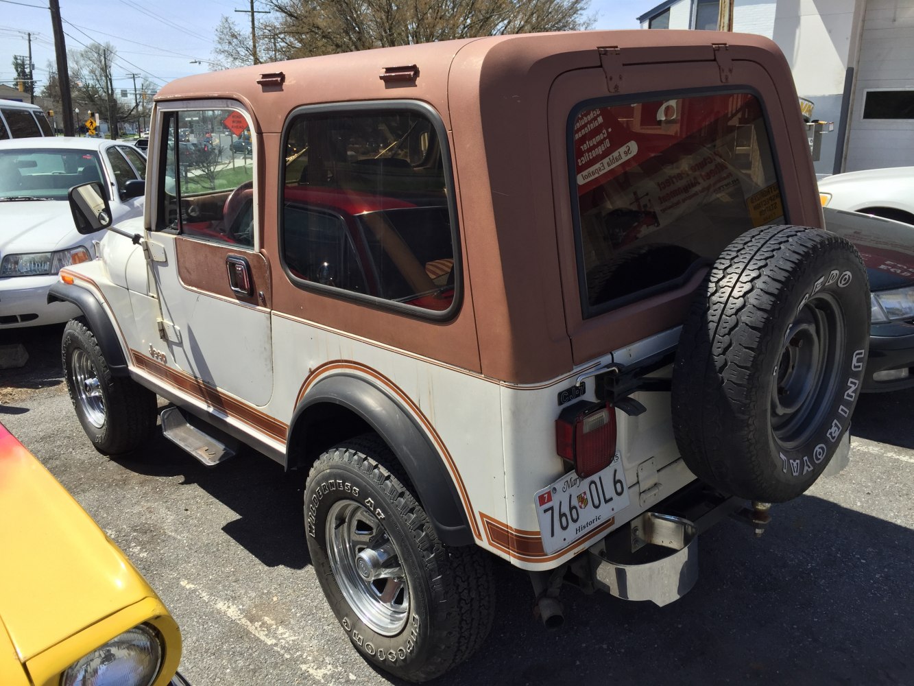 Hardtop SUV with rear-mounted spare tire and rugged off-road tires