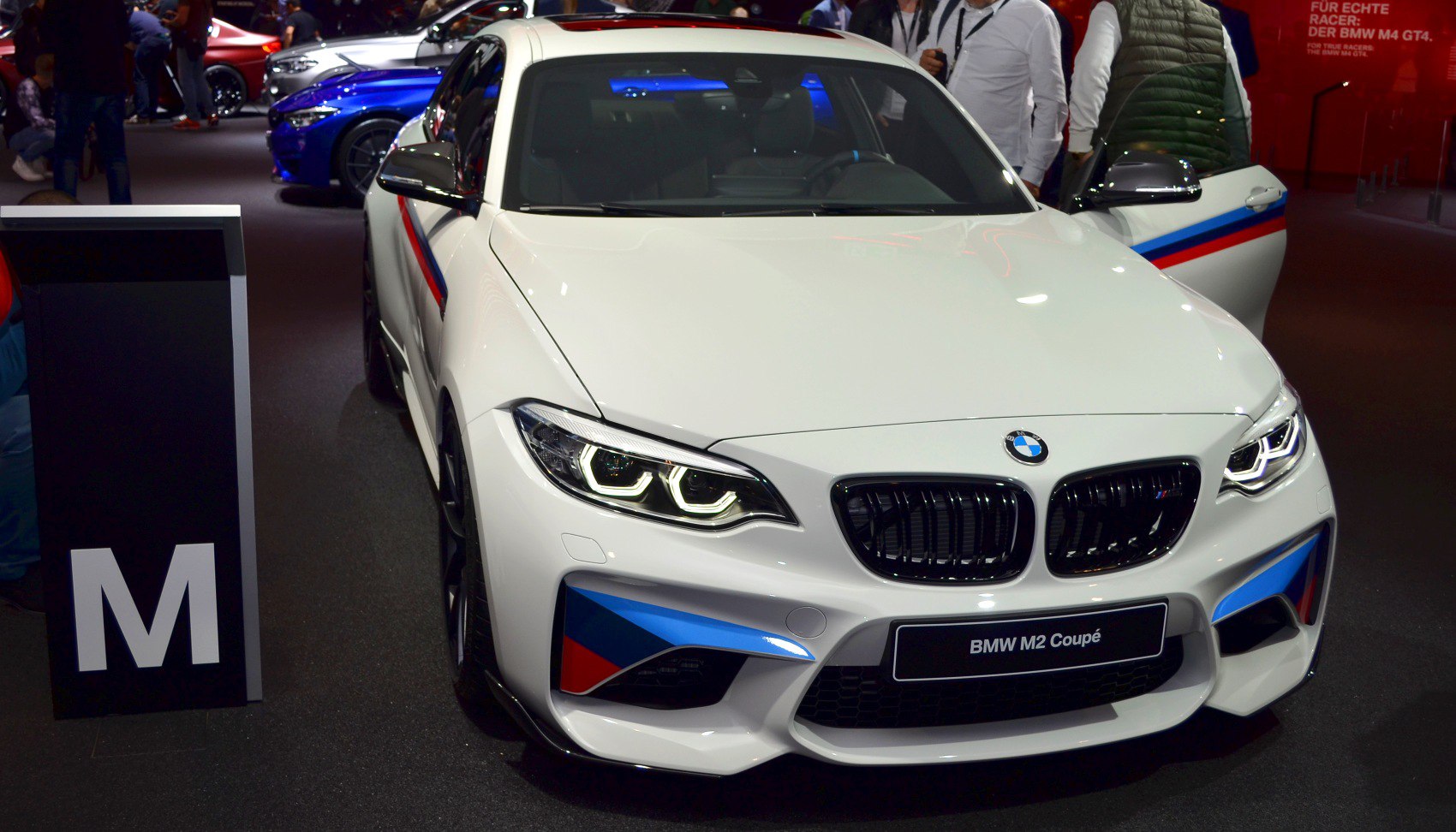 Front view of sporty BMW M2 coupe with LED headlights and M stripes
