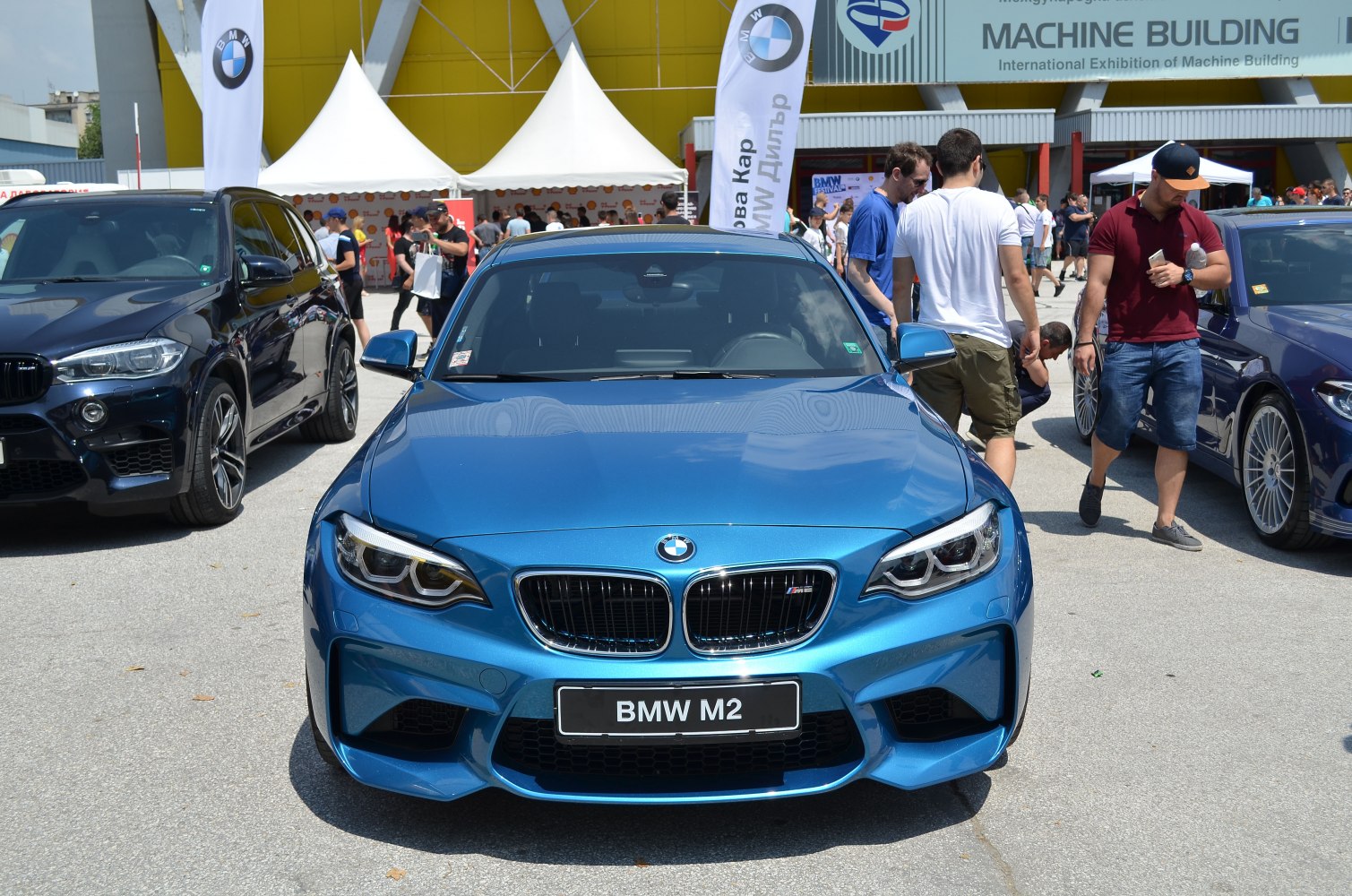 Blue BMW M2 coupe front with grille and headlights