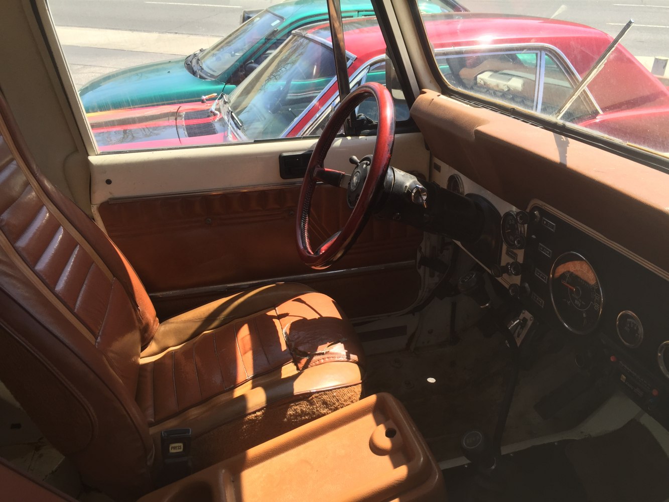 Worn leather seat and classic dashboard with analog instruments