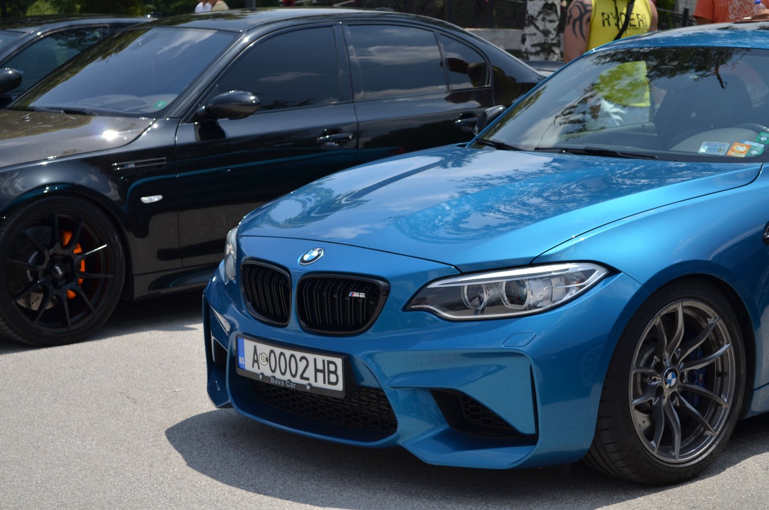 Close-up of aggressive front end with kidney grille and multi-spoke wheel.