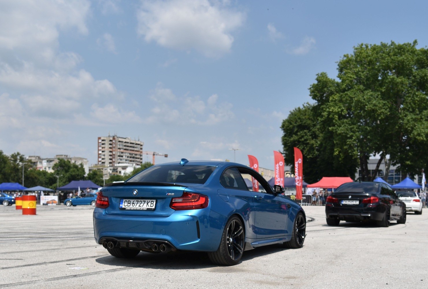 Blue sports coupe rear with quad exhaust and performance wheels