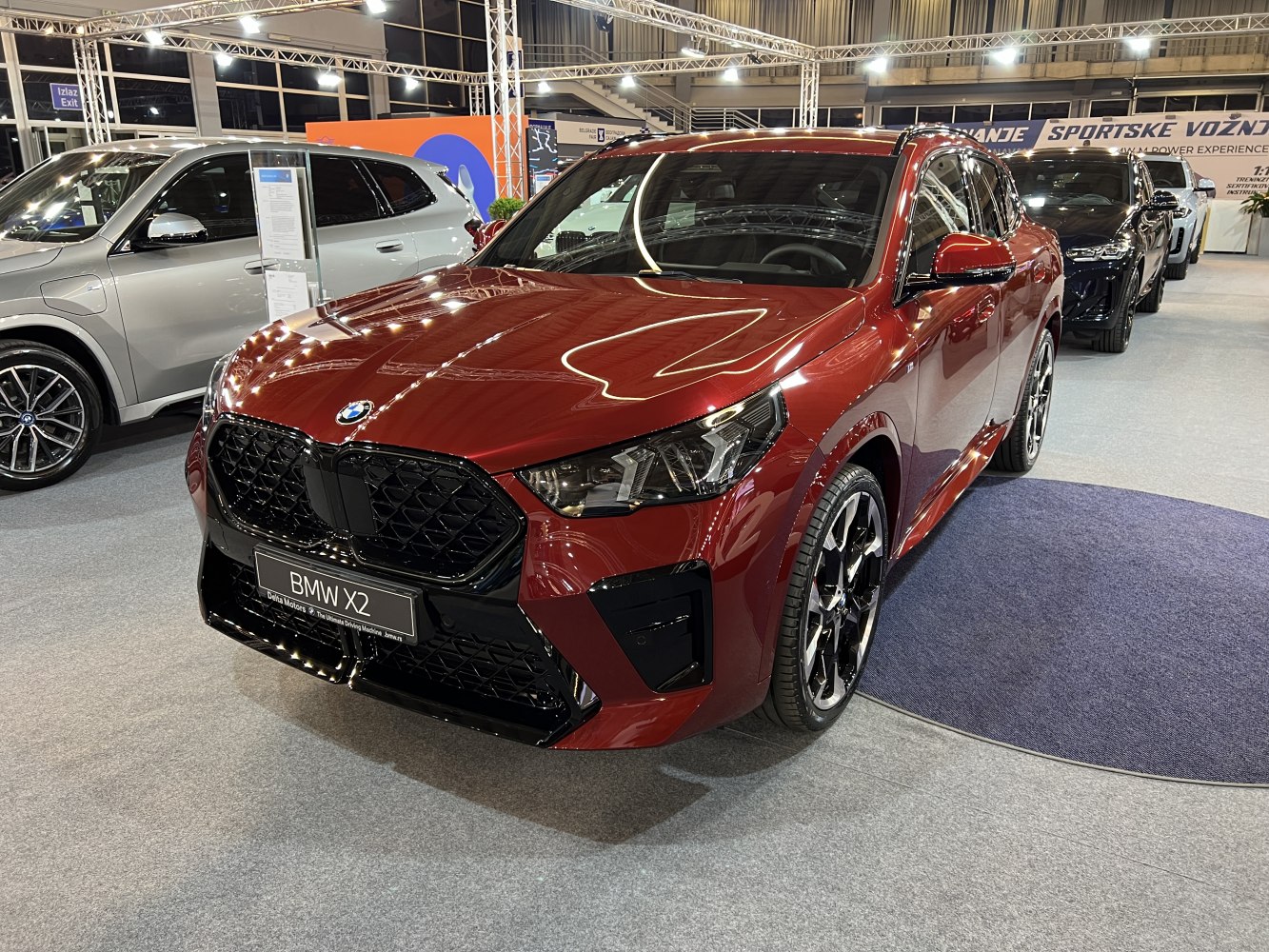 Red SUV front with black grille and distinctive alloy wheels