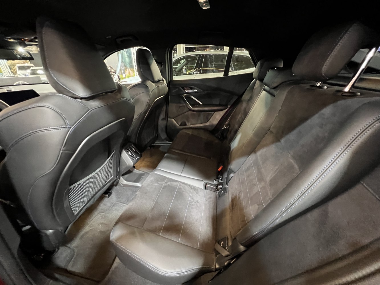 Rear seats with leather and Alcantara upholstery in spacious modern car interior