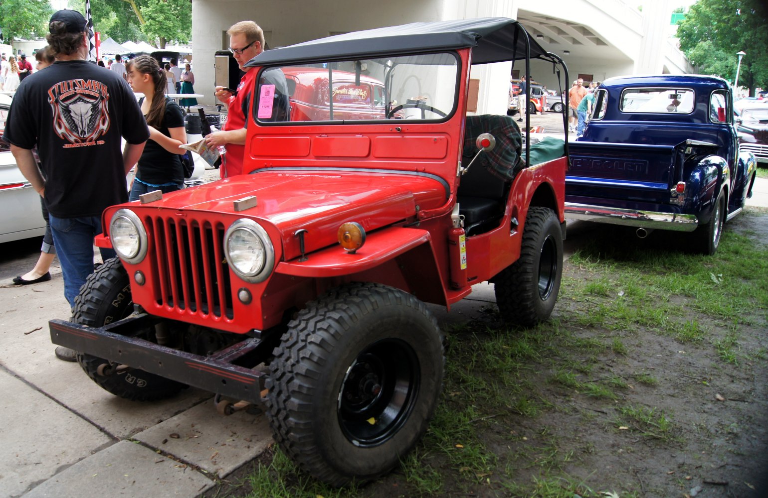 Vintage open-top Jeep with rugged off-road tires and flat fenders
