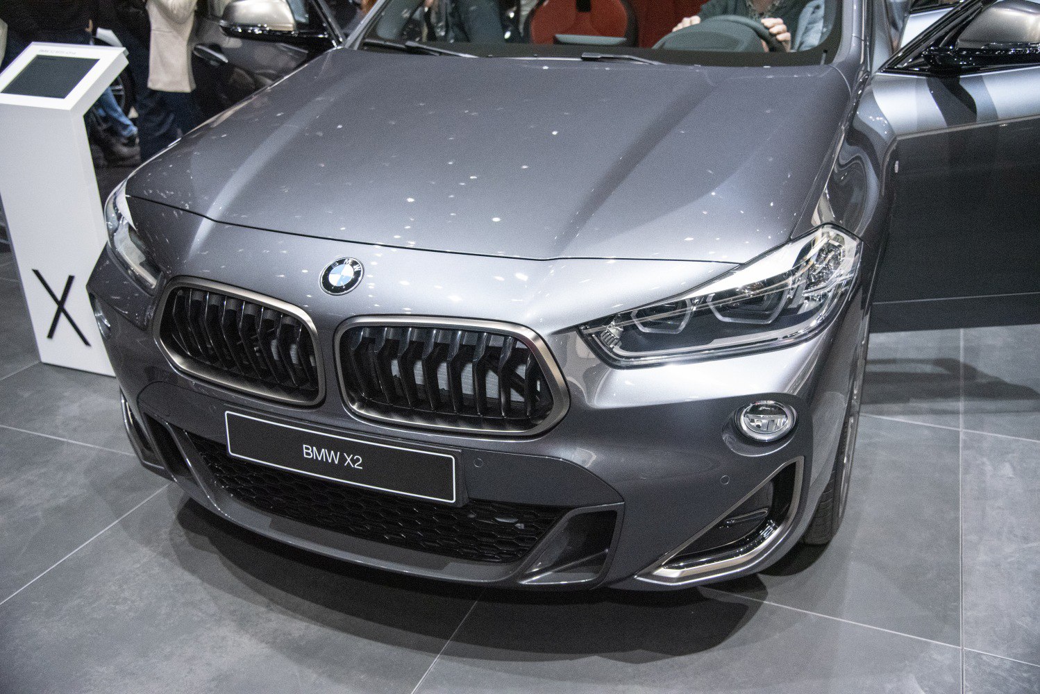 Close-up of aggressive front grille and modern headlights.