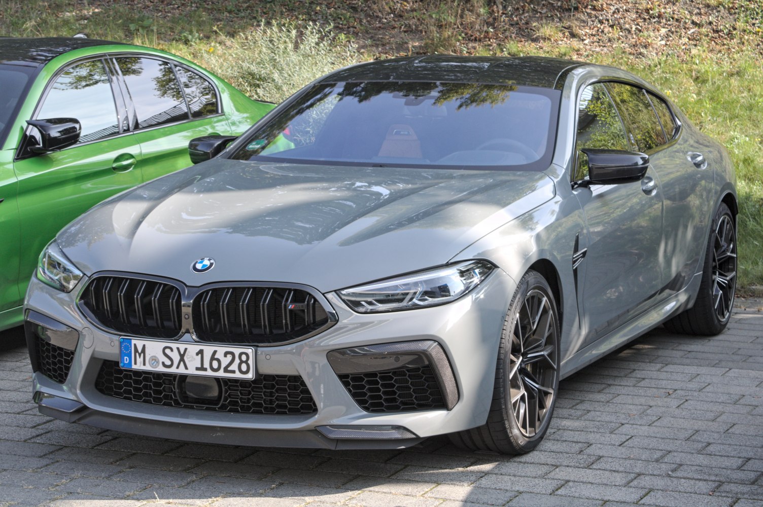 Front and side view of high-performance sports sedan with aggressive design.