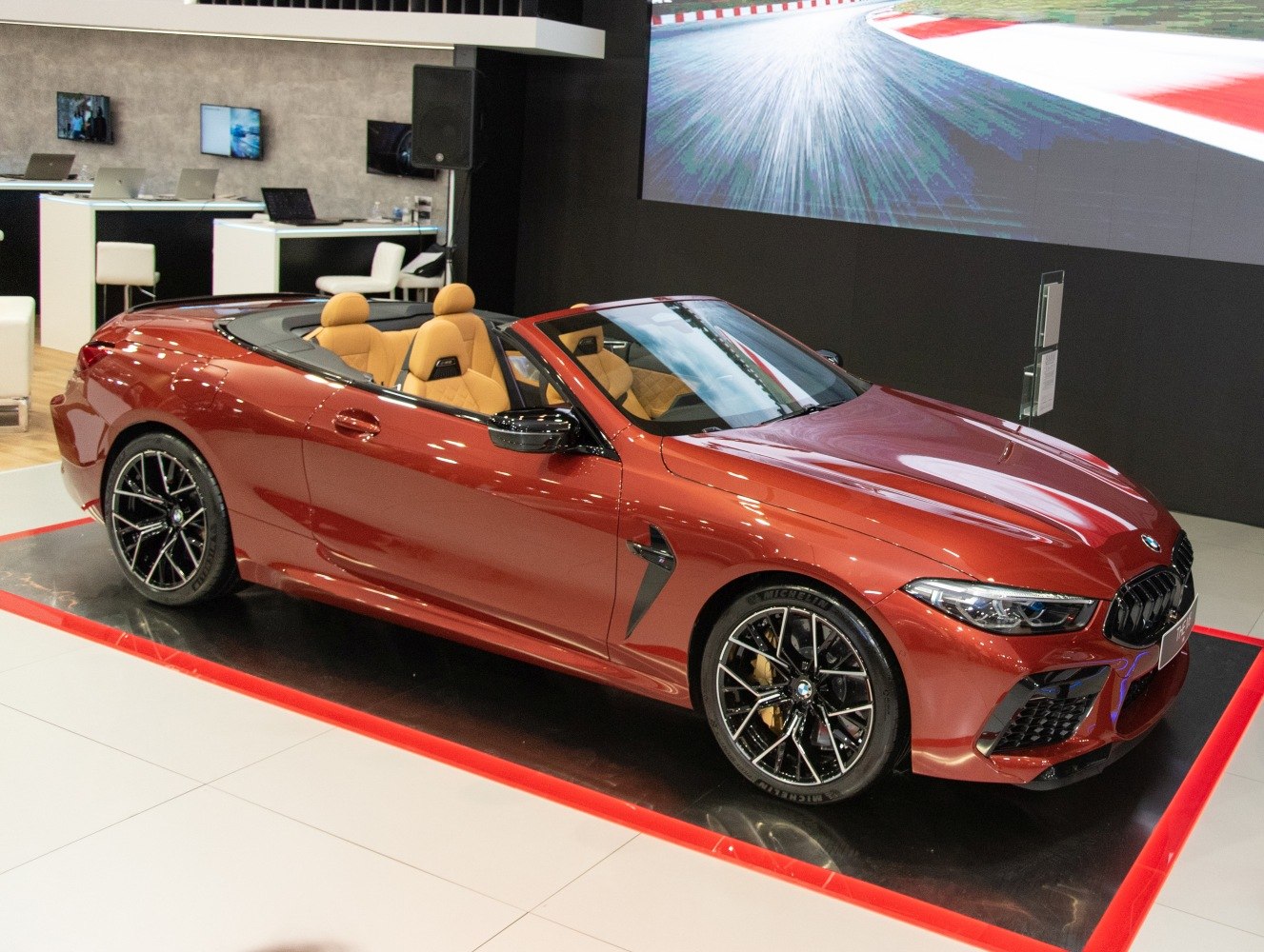 Sporty convertible with tan interior and black multi-spoke rims