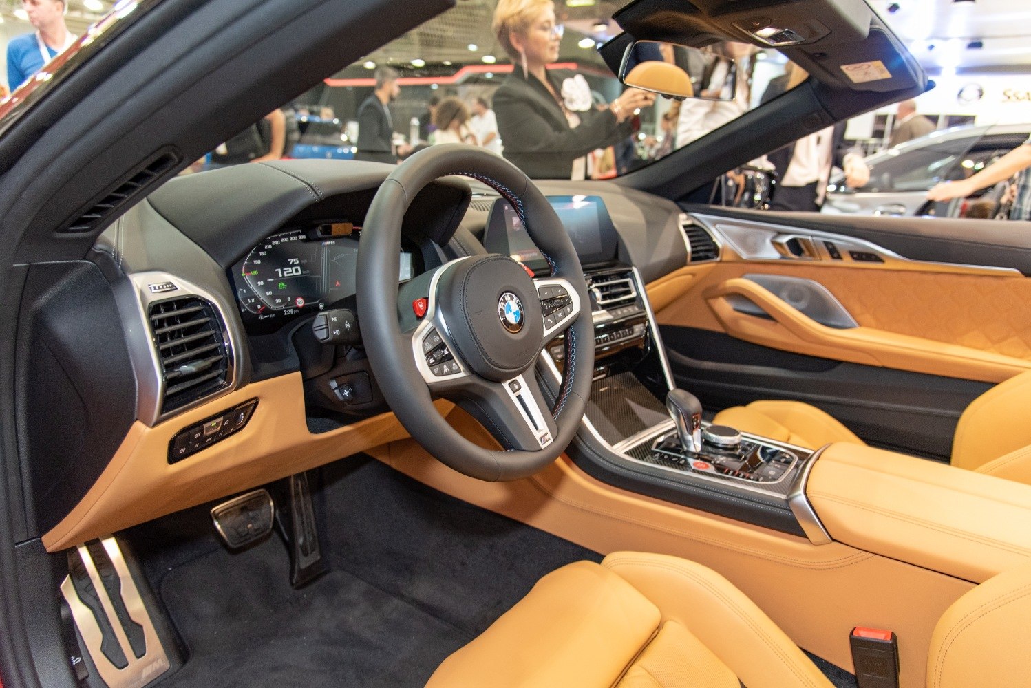 Luxury tan leather interior with digital dashboard and sporty steering wheel