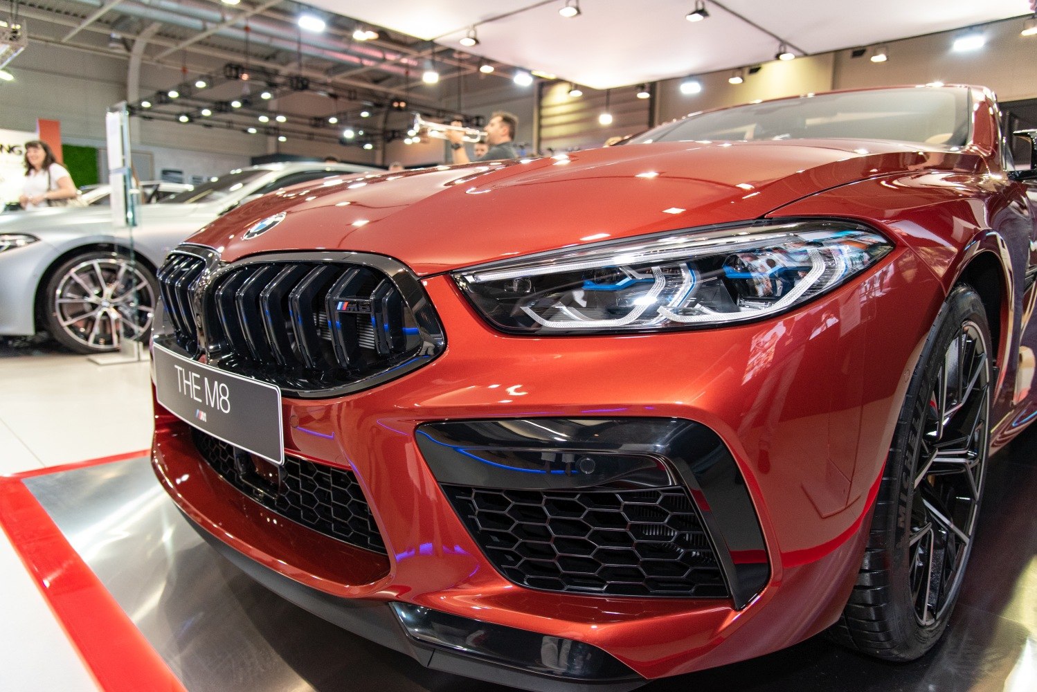Aggressive front grille and sleek headlight of a luxury sports convertible.