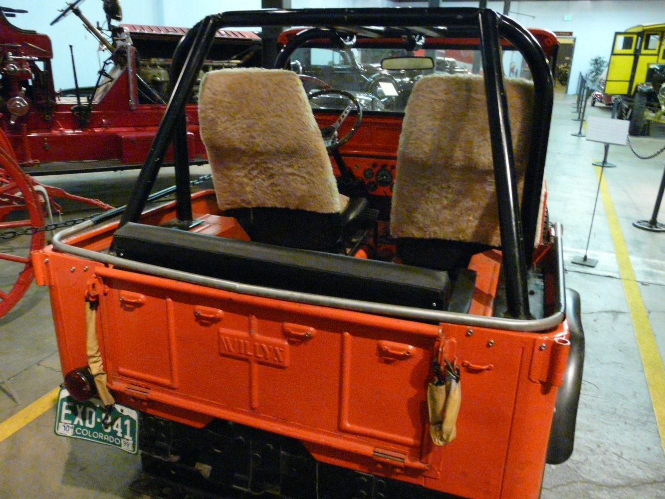 Rear open-top view with fuzzy seat covers and roll bar