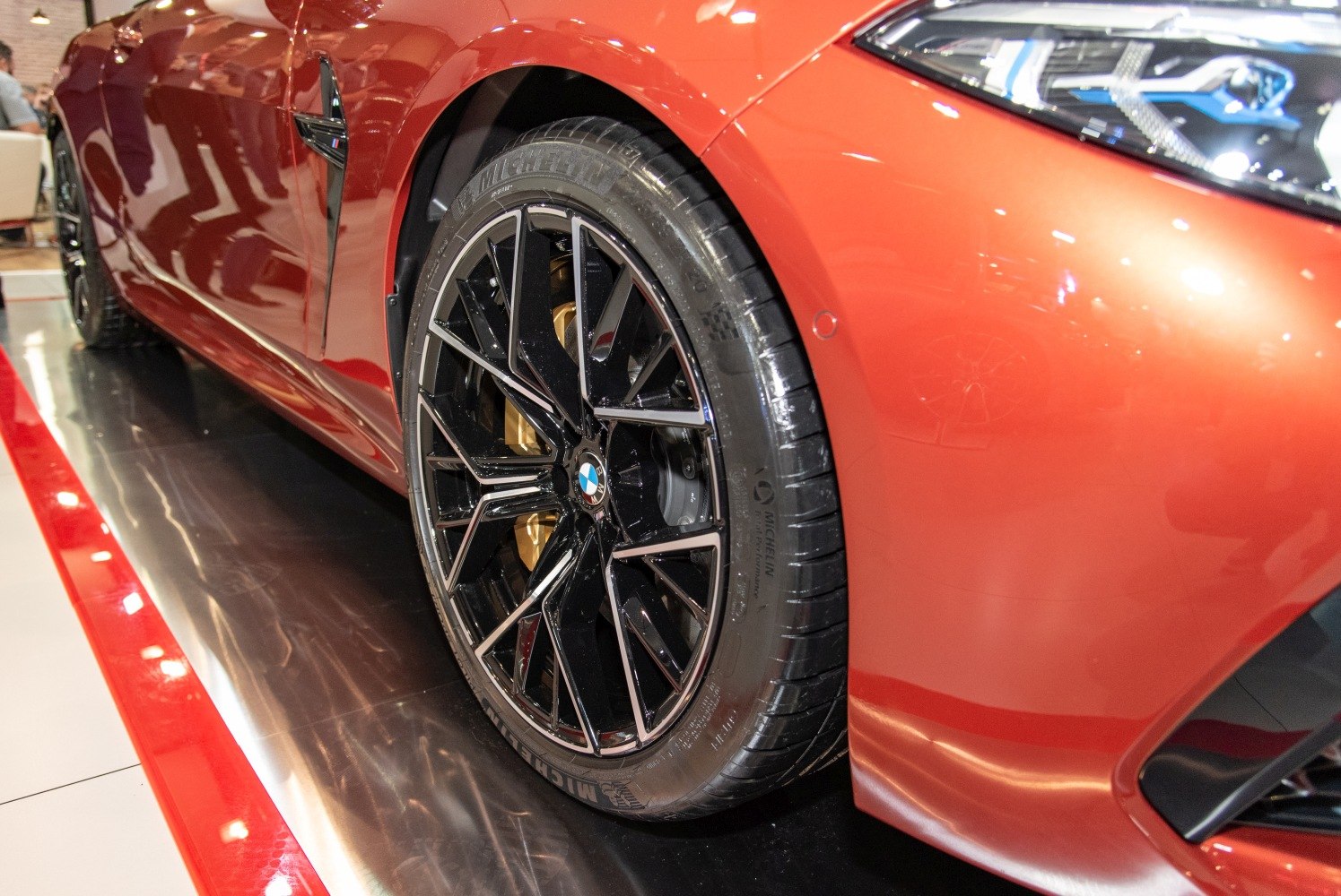 Close-up of front alloy wheel with Michelin tire and stylish headlight