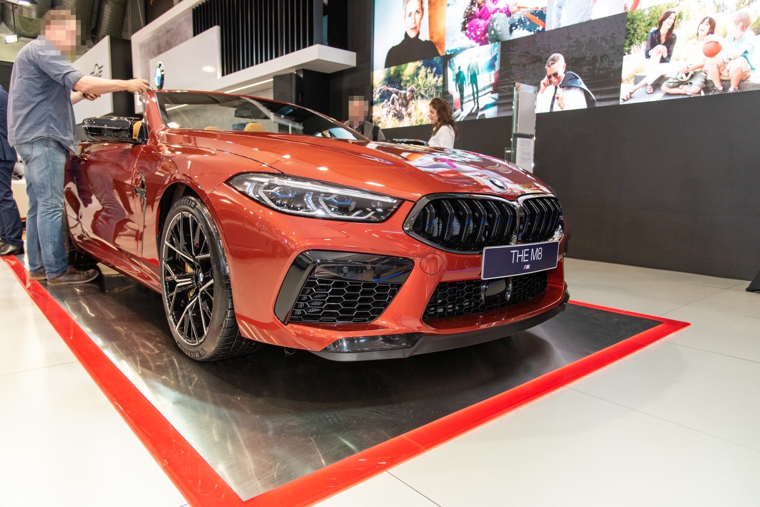 Close-up of front view of orange convertible with black grille and sporty headlights