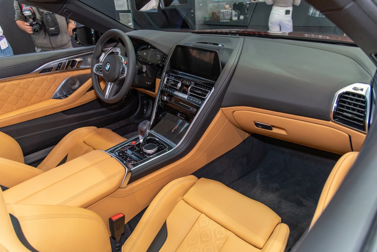 Luxury tan leather interior with advanced infotainment and modern dashboard.