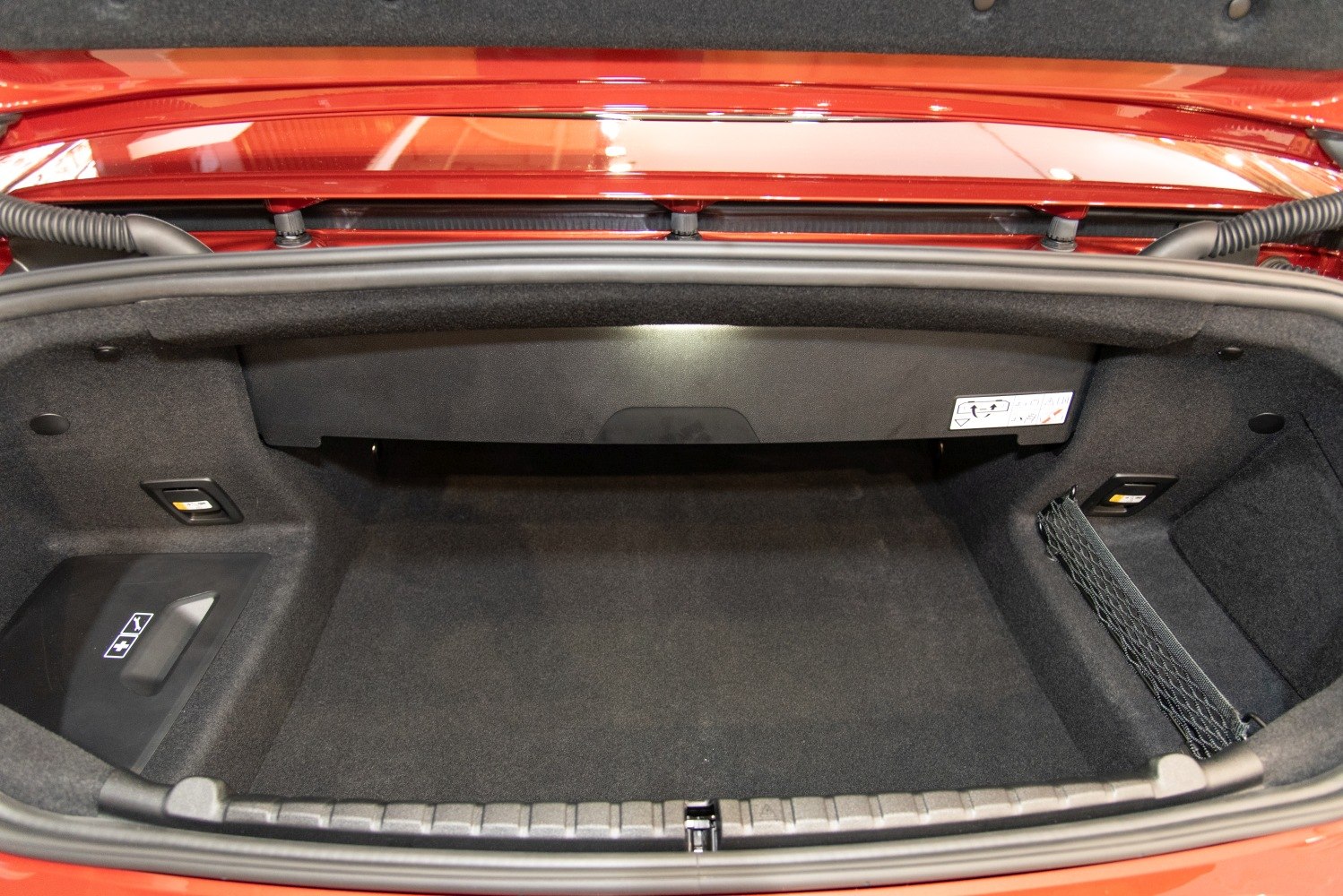 Spacious, carpeted trunk interior with side net and secure compartments
