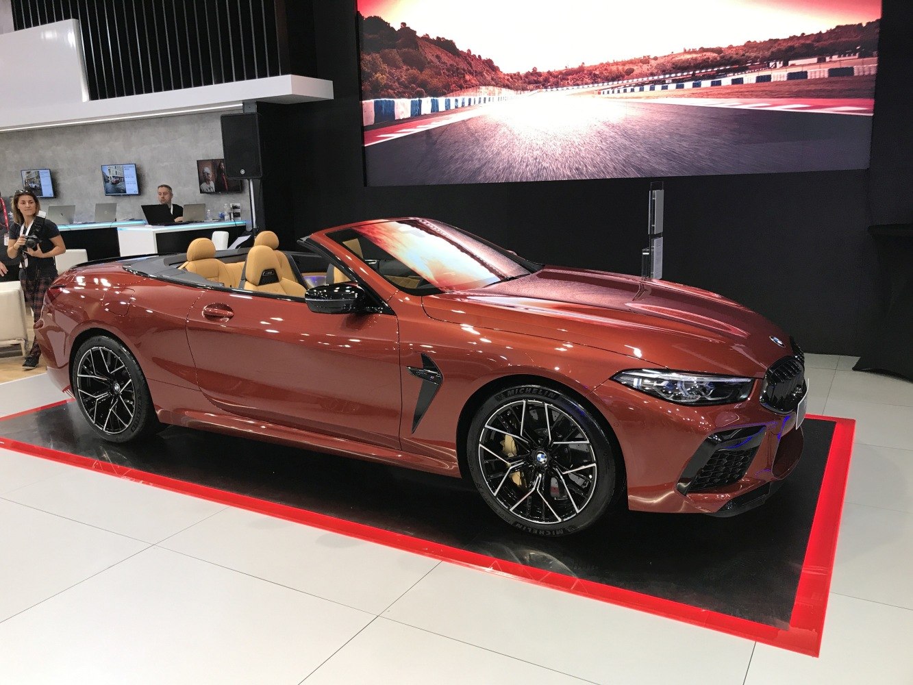 Luxury convertible with black multi-spoke alloy wheels and tan leather interior