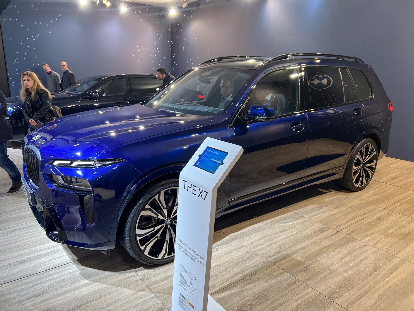 Front and side view of a sleek modern SUV with distinctive LED headlights and large alloy wheels.
