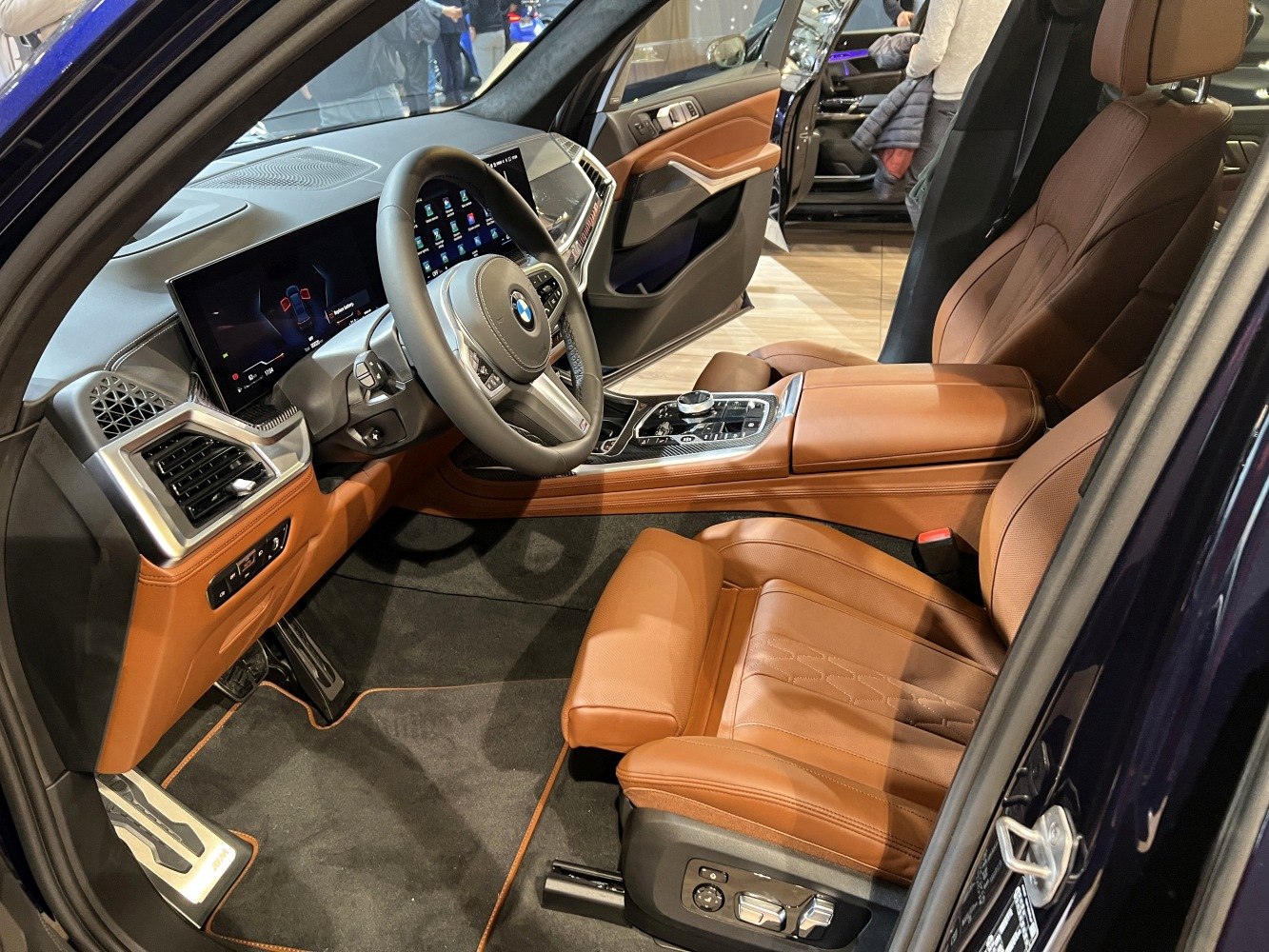 Brown leather seats and digital dashboard with steering wheel