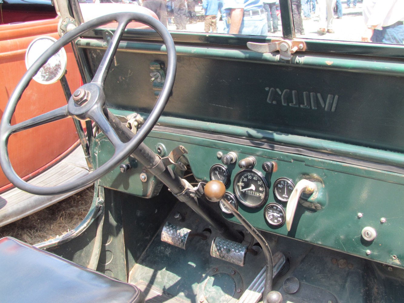 Vintage dashboard, steering wheel, and pedals interior close-up