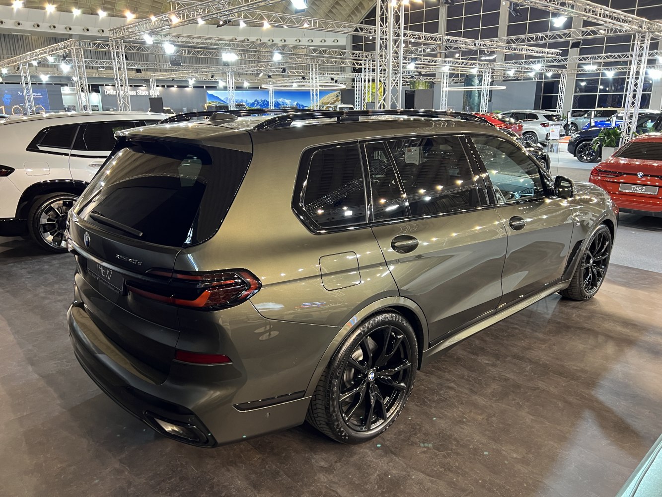 Rear and side view of luxury SUV with black alloy wheels and roof rails