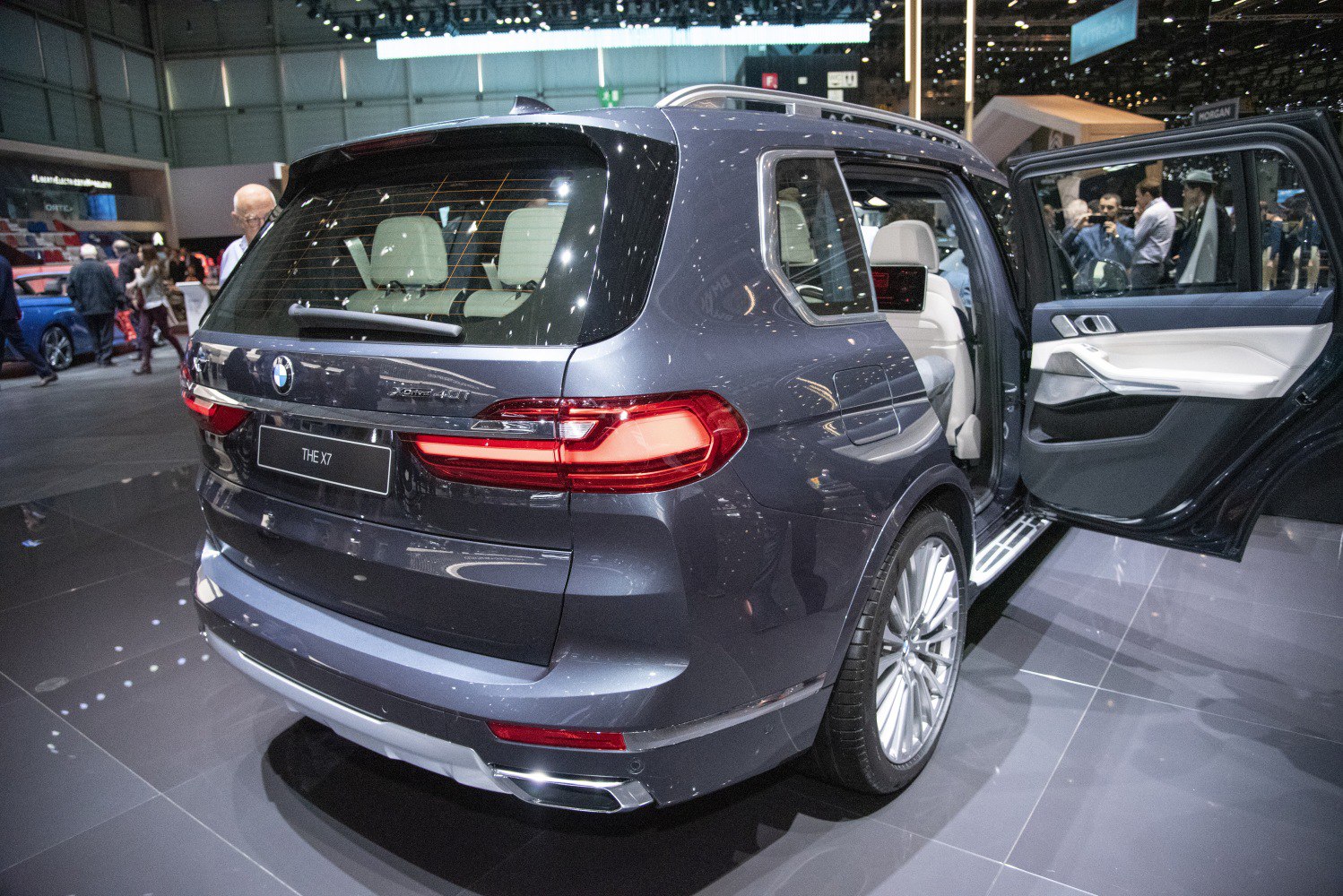 Rear view of luxury SUV with open rear door and detailed taillights