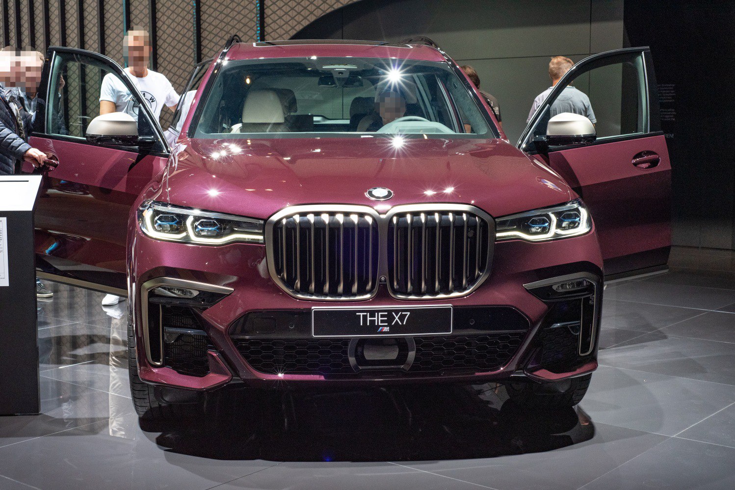 Front view of SUV with large kidney grille and open doors