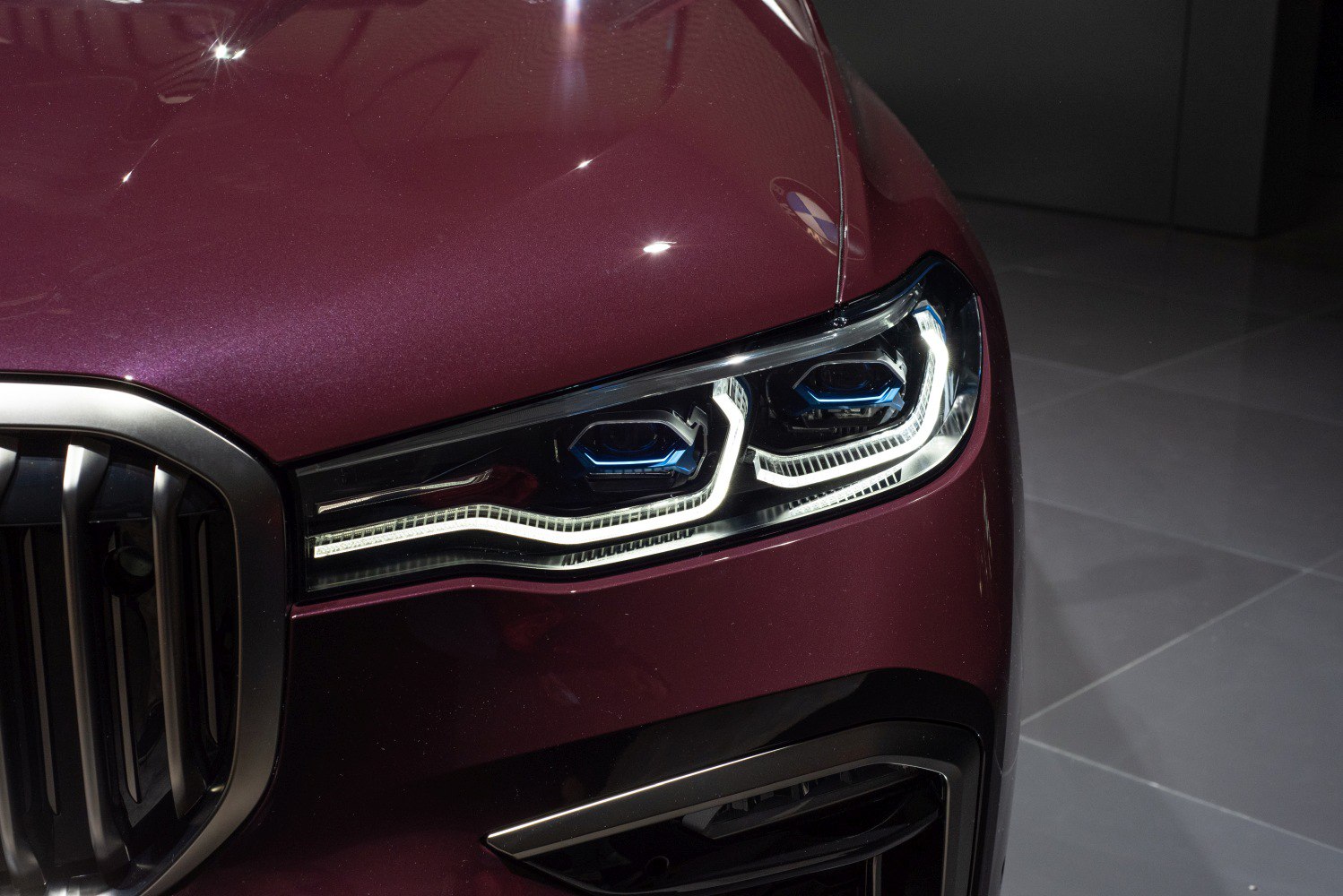 Front LED headlight and grille close-up on luxury SUV