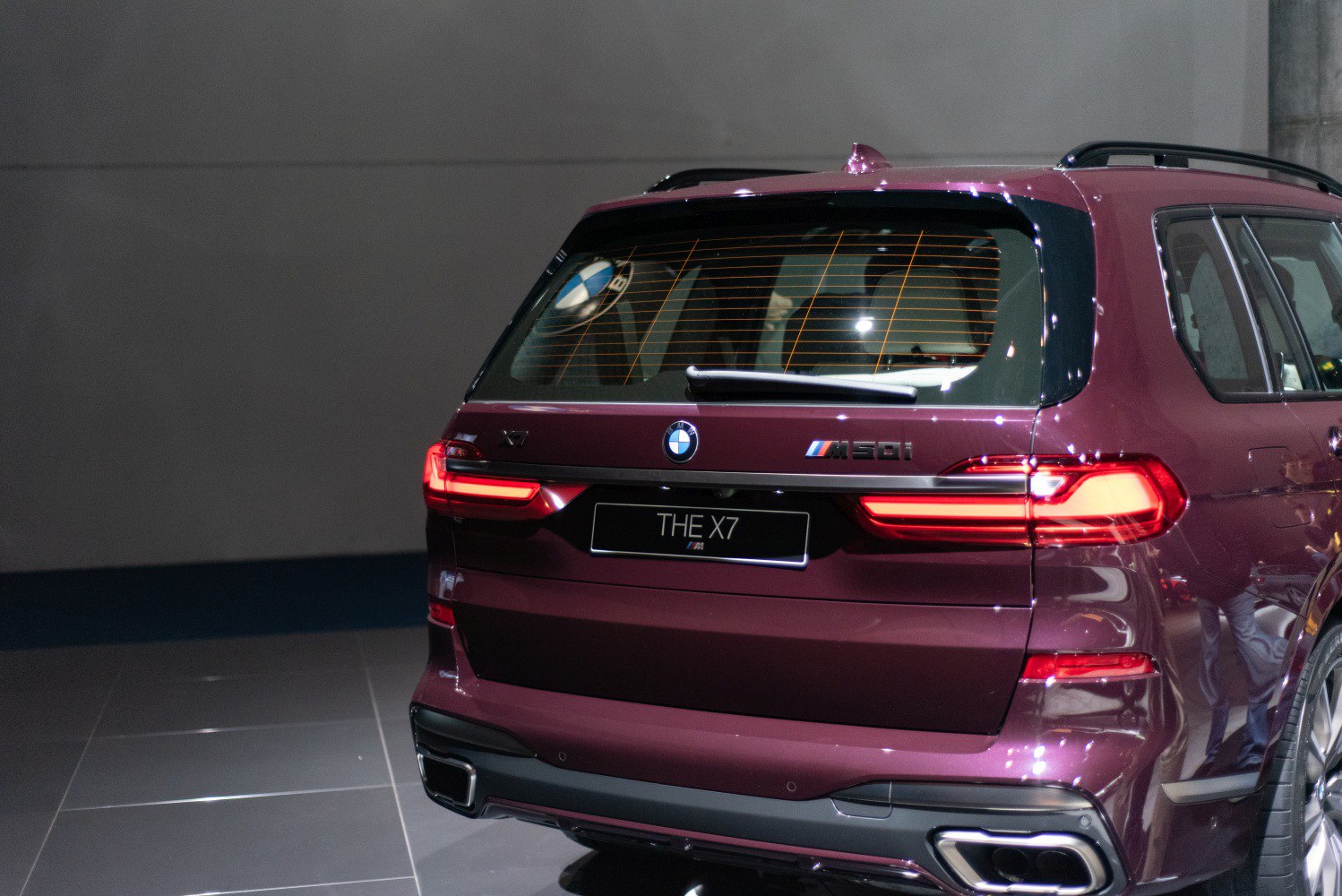 Rear view with distinct LED tail lights and M60i badge