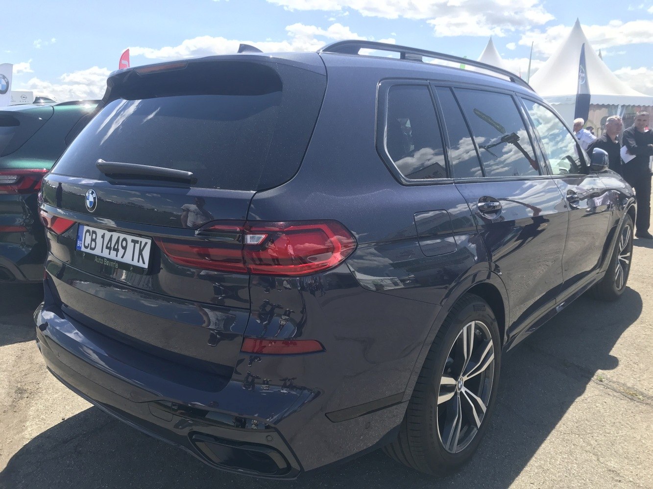 Rear view of a luxury SUV with sleek taillights and roof rails
