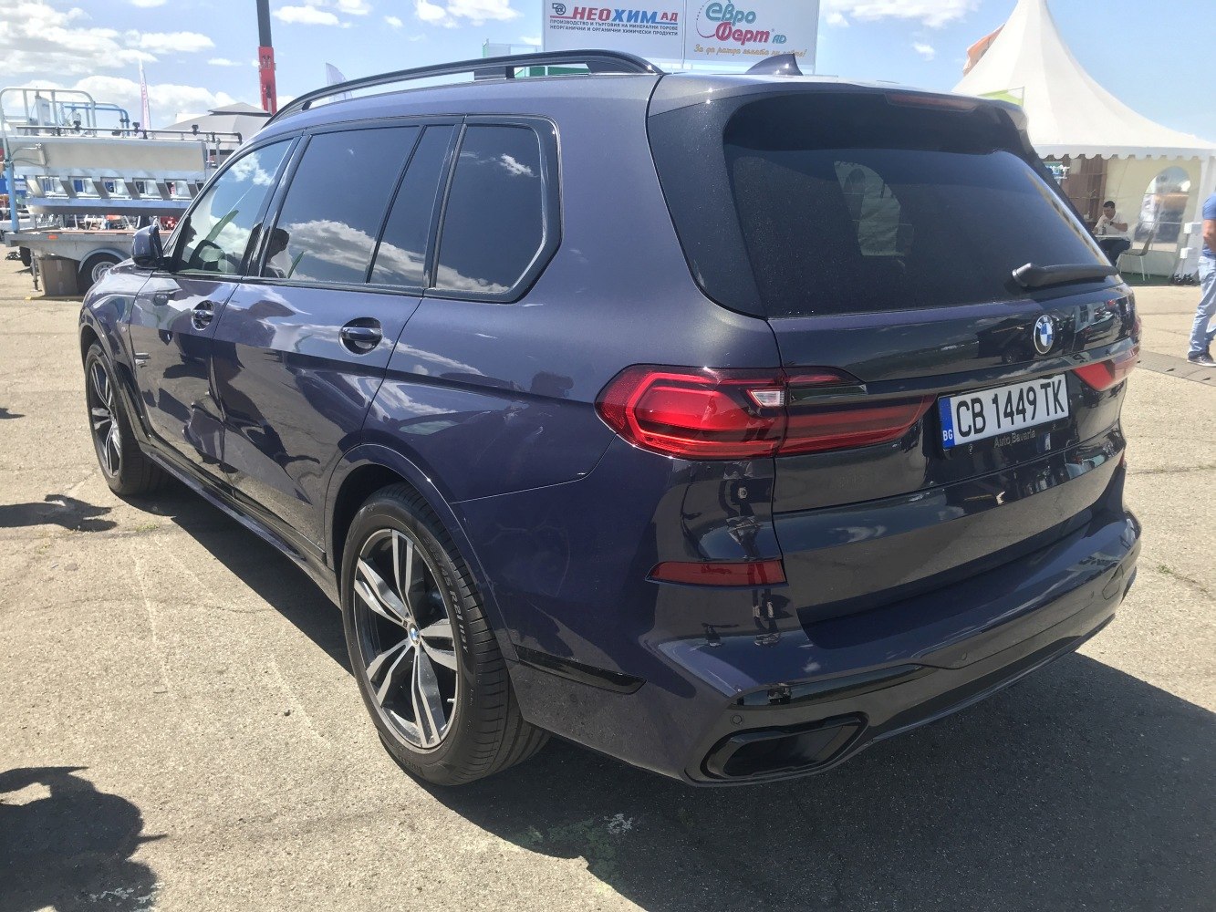 Rear angle view highlighting tail lights, alloy wheels, and tinted windows of a luxury SUV.