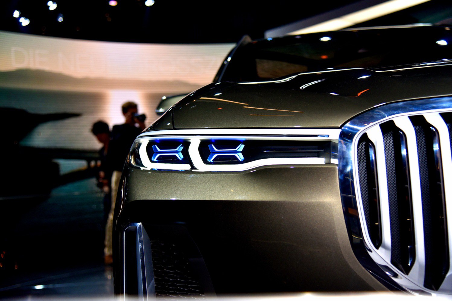 Close-up of futuristic LED headlights and large kidney grille
