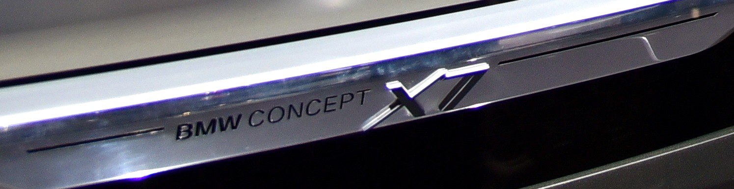 Close-up of BMW X7 Concept door sill metal trim with engraved branding